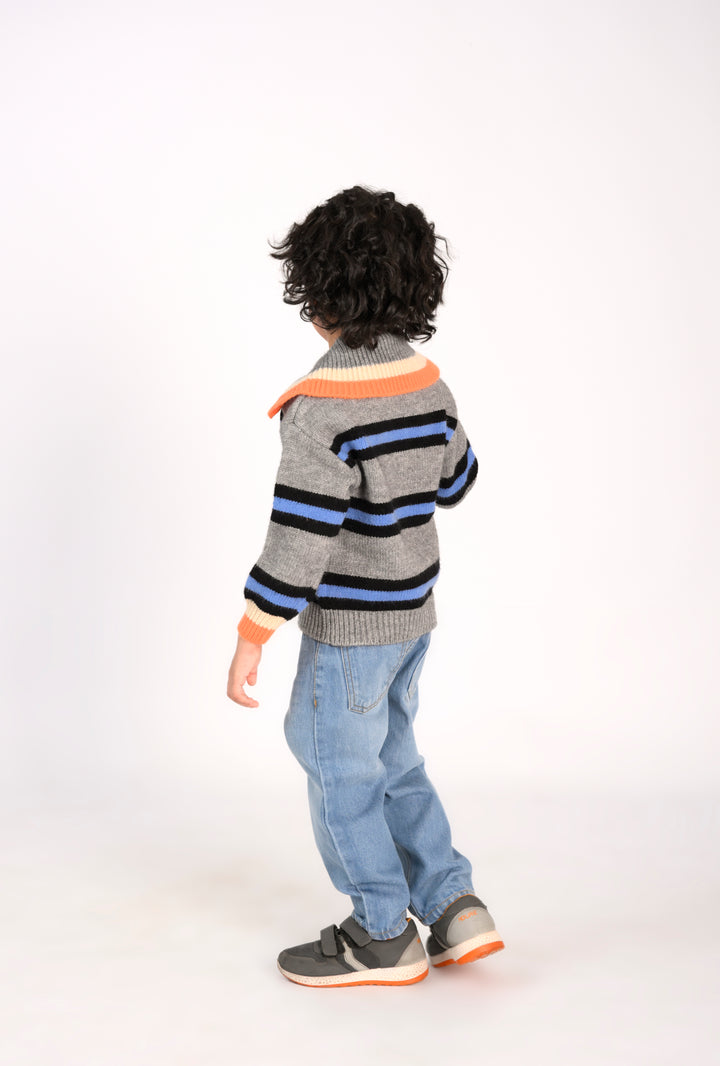 Boy in a Striped Sweater and Light Wash Jeans Reality