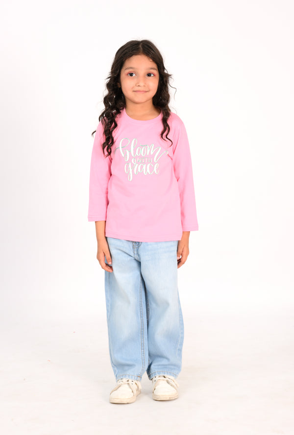 Young Girl in Pink "Bloom with Grace" Shirt and Light Wash Jeans Reality