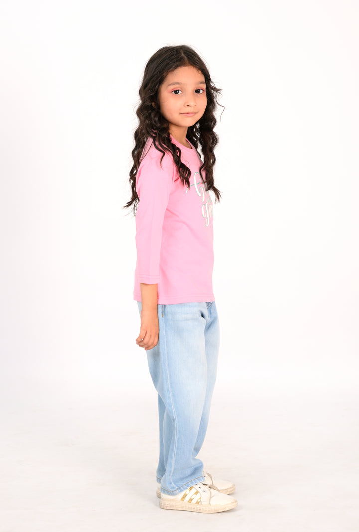 Young Girl in Pink "Bloom with Grace" Shirt and Light Wash Jeans Reality