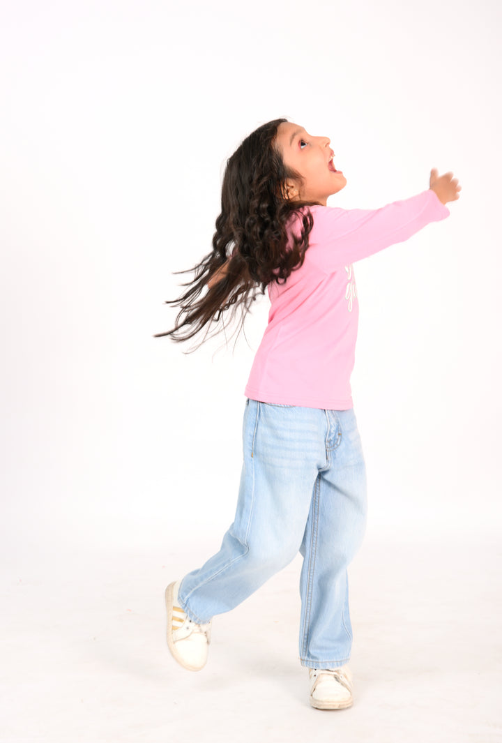 Young Girl in Pink "Bloom with Grace" Shirt and Light Wash Jeans Reality