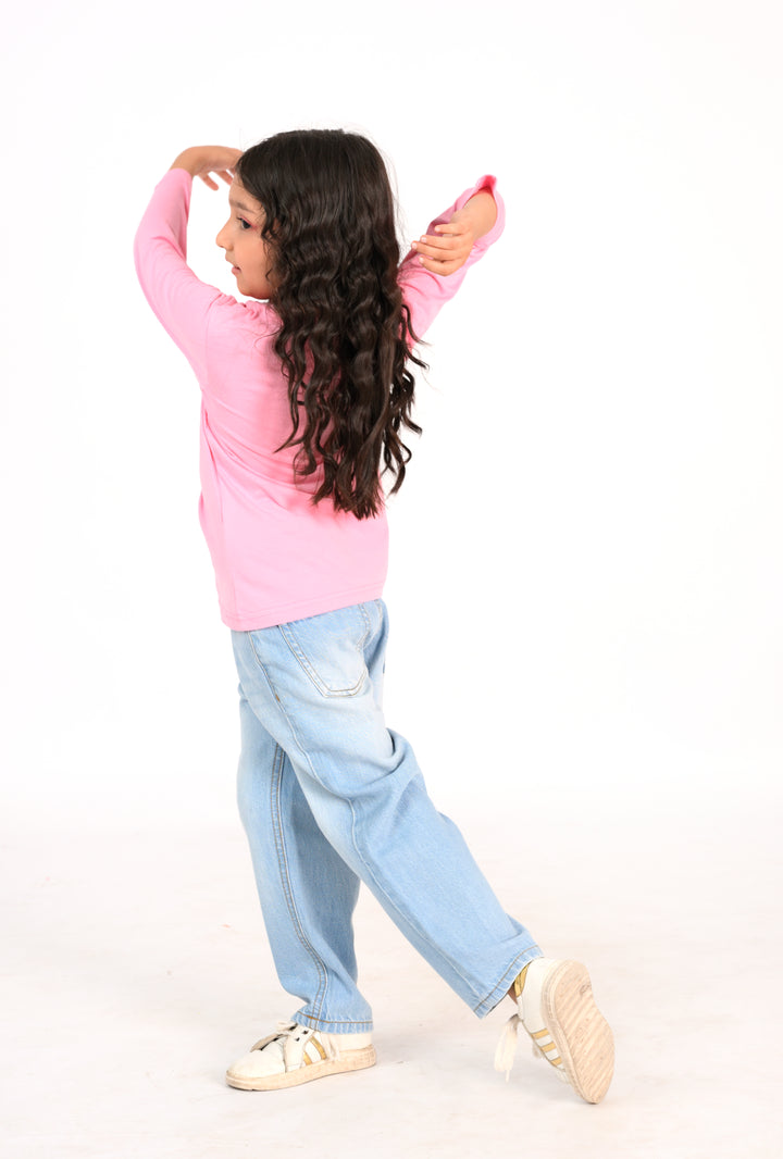 Young Girl in Pink "Bloom with Grace" Shirt and Light Wash Jeans Reality